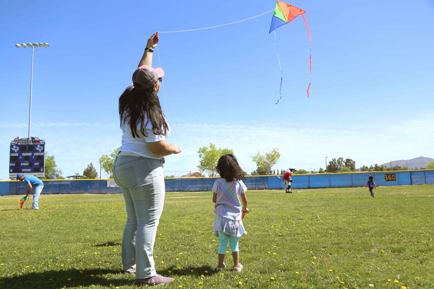 Voices United Executive Director Ambar M. Gutierrez flies a kite with her daughter at the first annual Kite Festival on Saturday, May 19, at Ernie Rascon Memorial Park.
