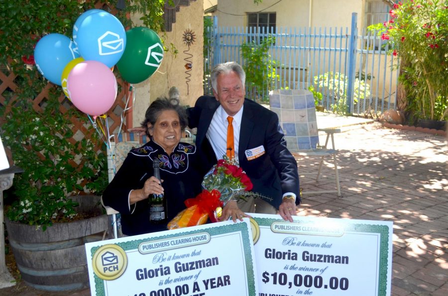 Dave Sayer of the Publishers Clearing House Prize Patrol poses for a photo with prize winner Gloria Guzman. 