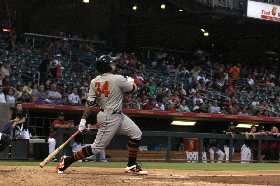 Nick Tanielu hits the ball.