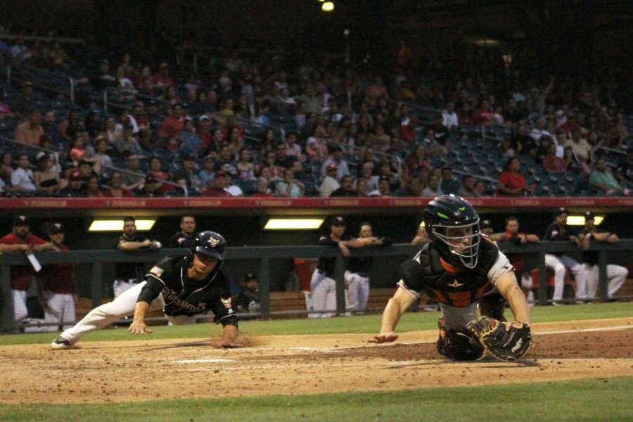 Carlos Asuaje slides into home-base. 