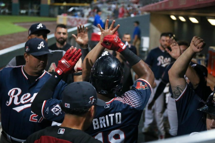 The Reno Aces celebrate as right fielder Socrates Brito scores a run 