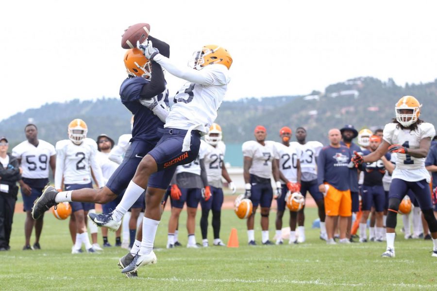 Wide receiver Treshon Wolf and defensive back Justin Rogers fight for possession of the ball. 