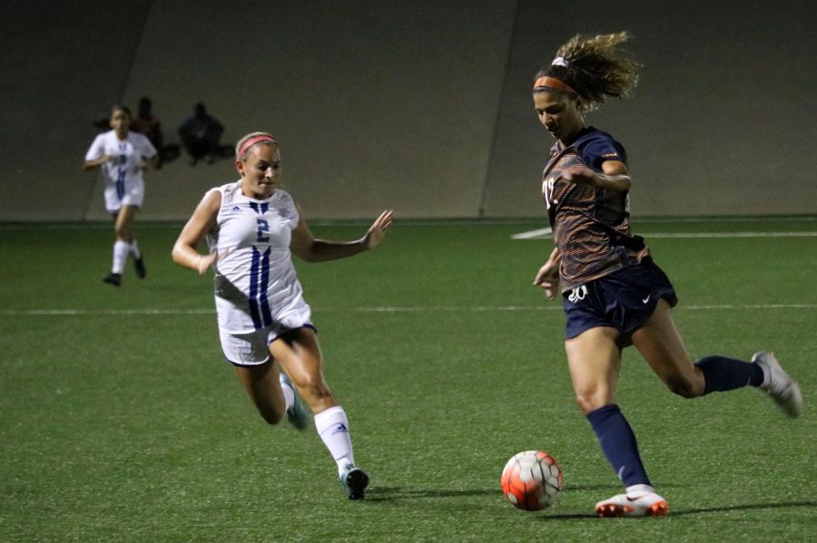 Sophomore Anna Jimmerson runs through the sidelines as she protects the ball from Lubbock Christian University