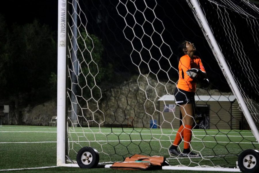 Goalkeeper Senior Alyssa Palacios prays before penalty.