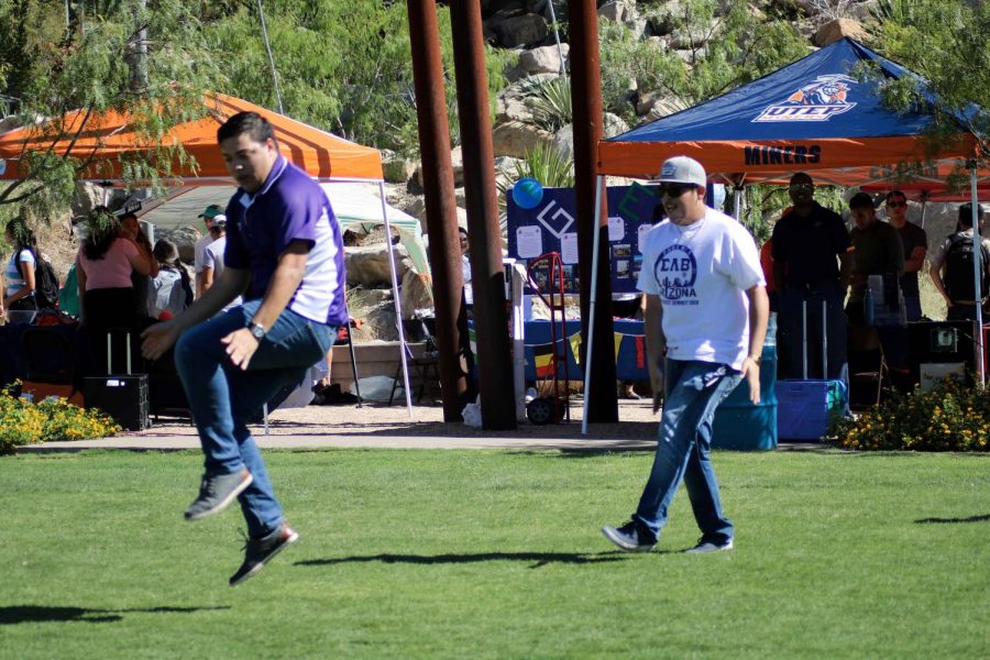Latin American and Border Studies graduate student Luis Suira and junior org and corp communications major Andres Adame dance at Miner Welcome at Centennial Plaza.