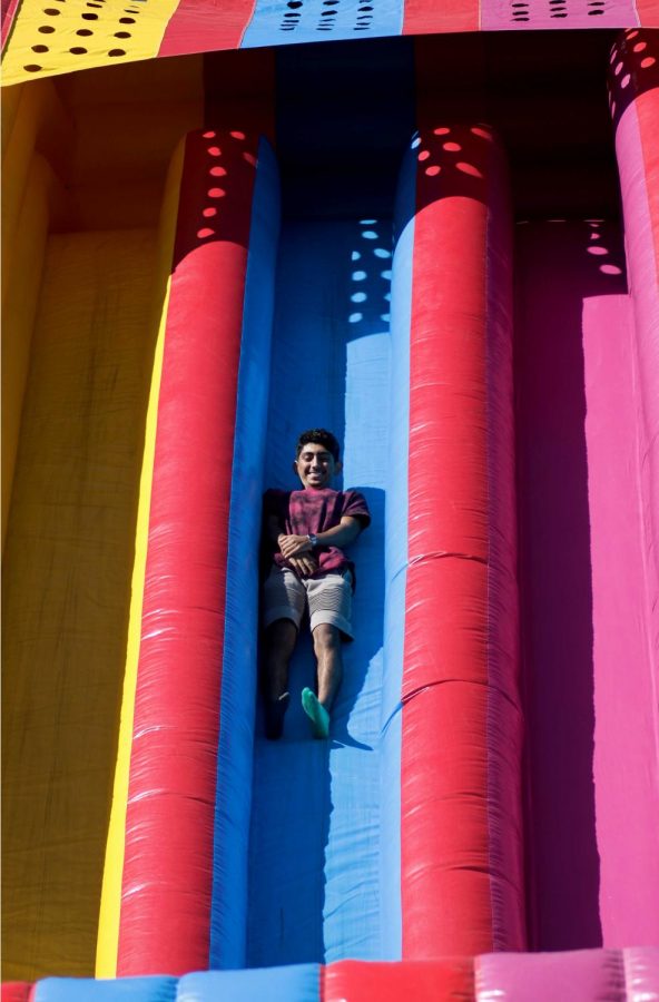 Sophomore mechanical engineering major Luis Gutierrez slides down the jumping balloon.