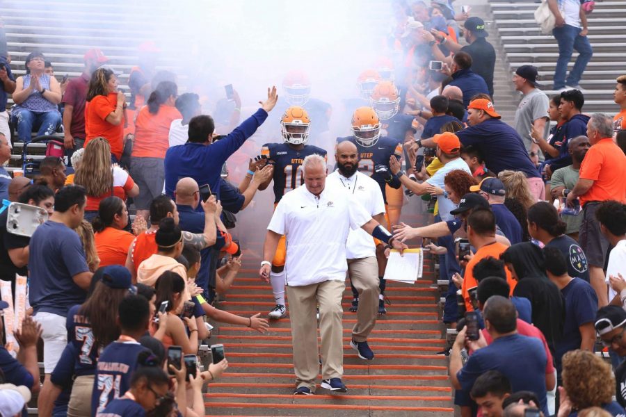 Football head coach Dana Dimel leads his team down the Mine Shaft during pre-game. 