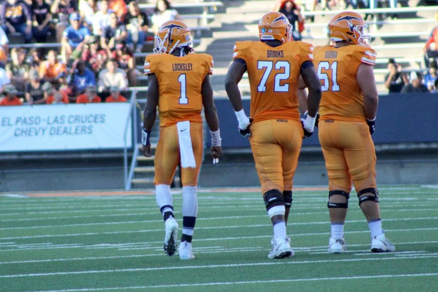 Junior quarterback Kai Locksley, senior offensive lineman Jared Brooks, and junior offensive lineman Ruben Guerra  wait for the play to be called.