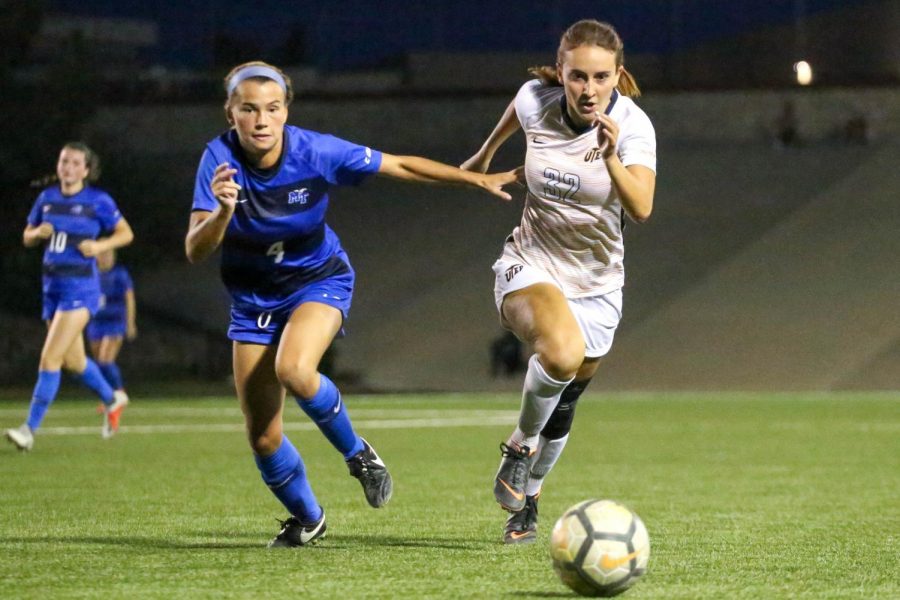 Sophomore midfielder April Pate and Middle Tennessee junior defender Casey River chase after a lose ball. 