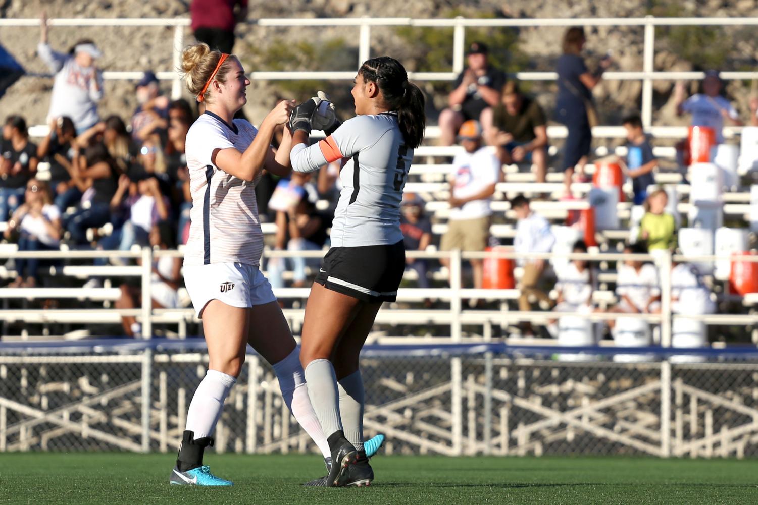 Senior goalkeeper Alyssa Palacios and senior defender Payton Ross celebrate as the miners score a second goal against NMSU.