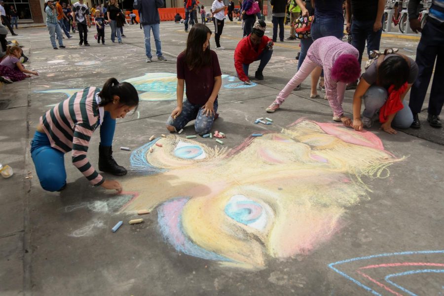 Artist work together to finish a chalk piece at day two of Chalk the Block on Saturday, Oct. 13. 