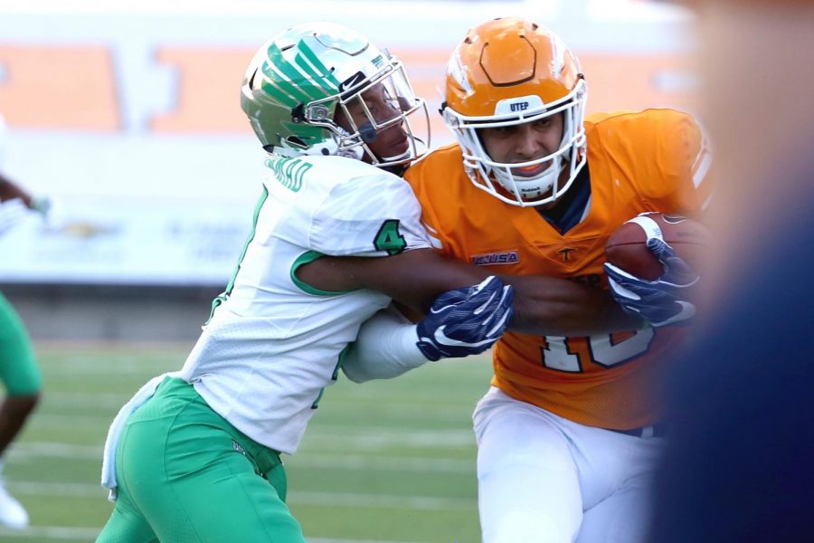 UNT junior KhairI Muhammad 
 makes the tackle on senior tight end David Lucero. 