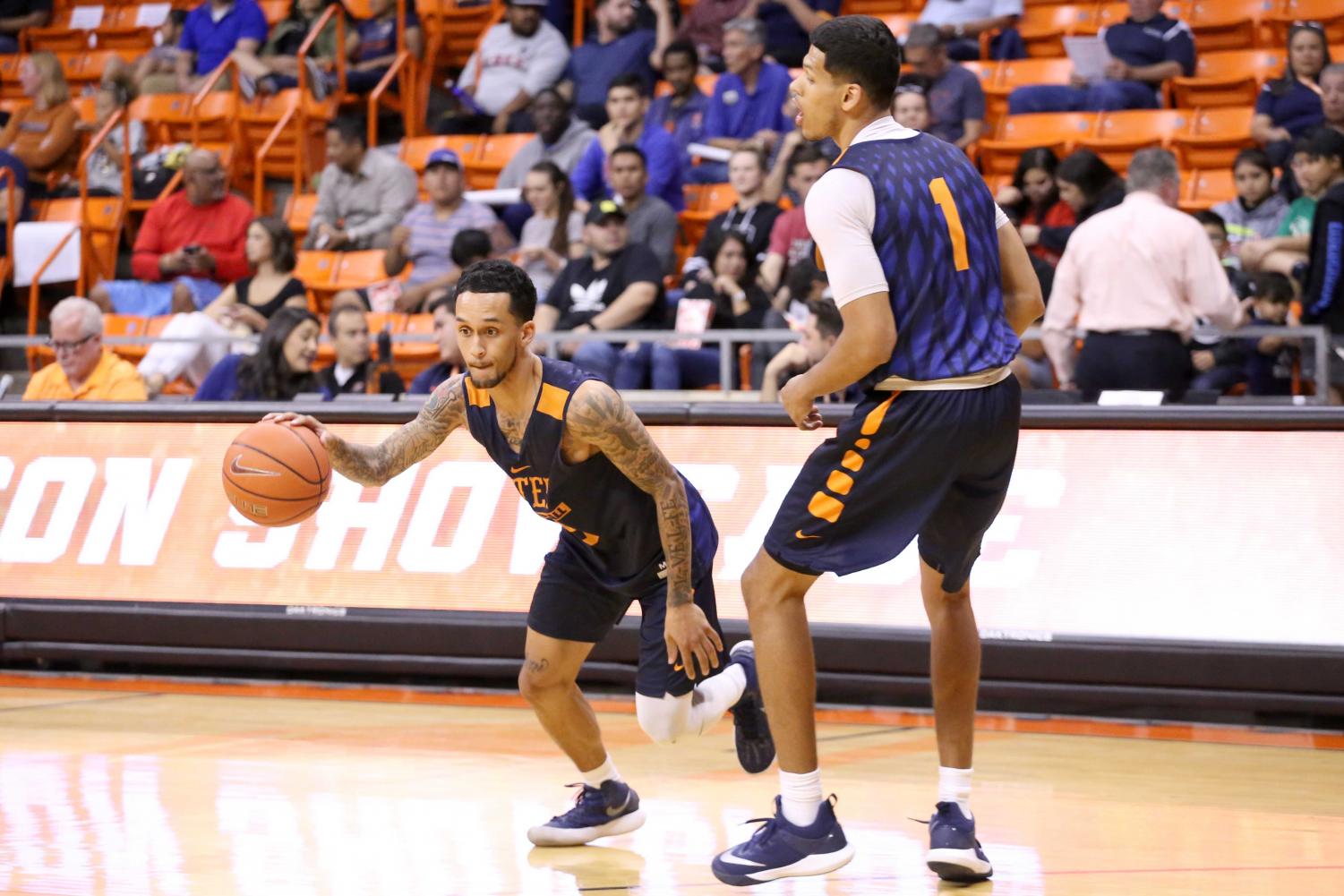 Sophomore guard Kobe Magee works on drills with senior Paul Thomas during the basketball pre season showcase at the Don Haskins Center on Wednesday, Oct. 10.