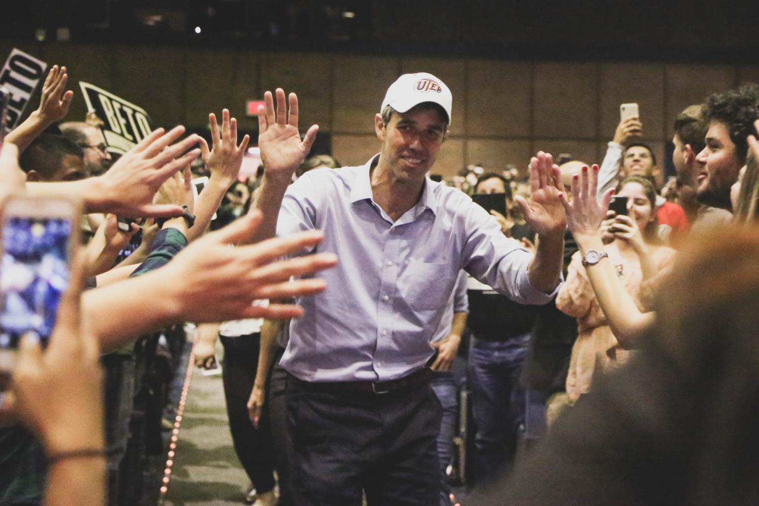 Congressman Beto O'Rourke high fives his supporters as he walks to take the stage at the Magoffin Auditorium for his final rally before election day on Monday, Nov. 5.