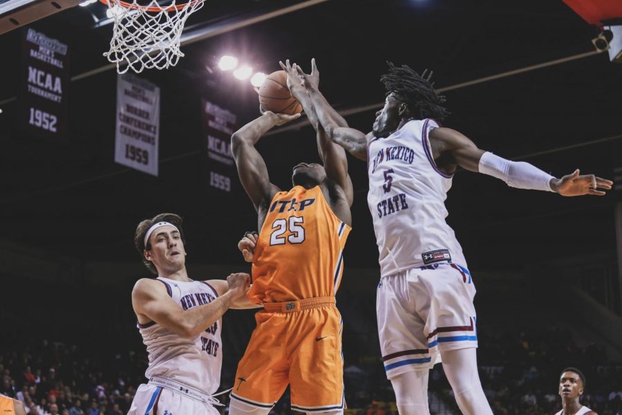 Freshman forward Kasoci Ezeagu  is blocked by NMSU junior guard Clayton Henry finished with 0 points. 