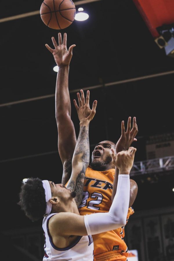 Freshman forward Efe Odigie shoots the ball above his defender finished with 12 points at the Battle of I-10. 