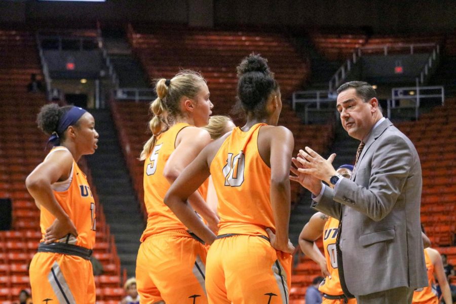 Womens basketball Head Coach Kevin Baker gives instructions during time out.