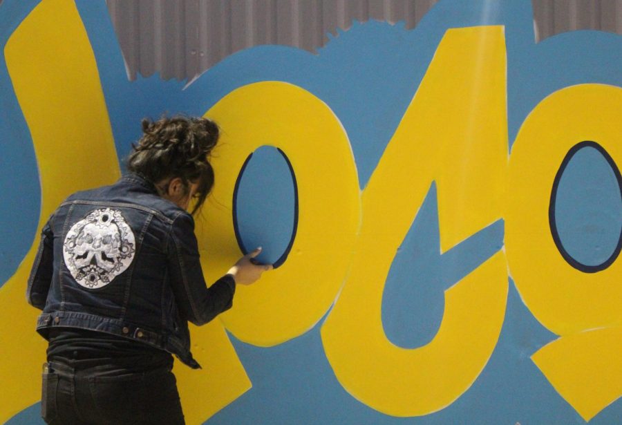 Local artist Christin Apodaca making the Locos graffiti mural. The fans nicknamed the team Locos which is short for Locomotives. 