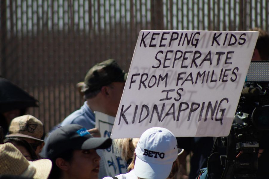 Democratic presidential candidate Beto ORourke supporters hold sign berating the detention of immigrant children on Sunday June 30, 2019.