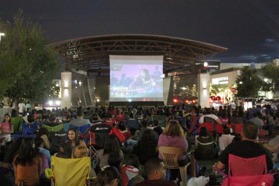People gather to watch the film “Selena” at the Fountains at Farah Saturday Sept. 14., 2019.