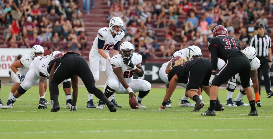 UTEP football redshirt senior center Derron Gatewood delivers a snap to Ryan Metz last season.