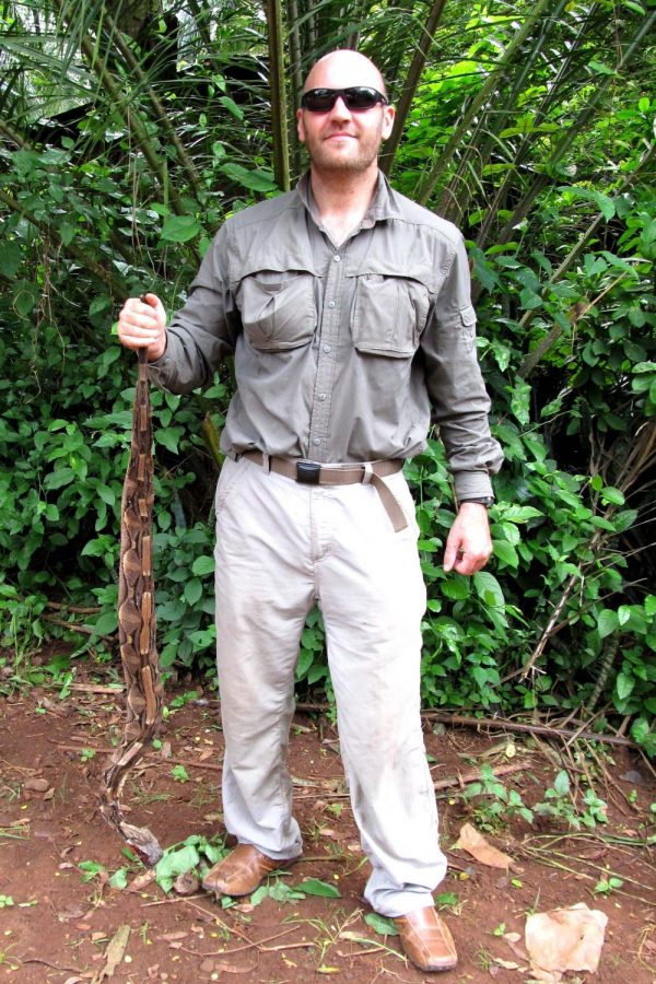 Eli Greenbaum, Ph.D., an associate professor of biological science at UTEP, holds a Gaboon viper in Congo, Africa.