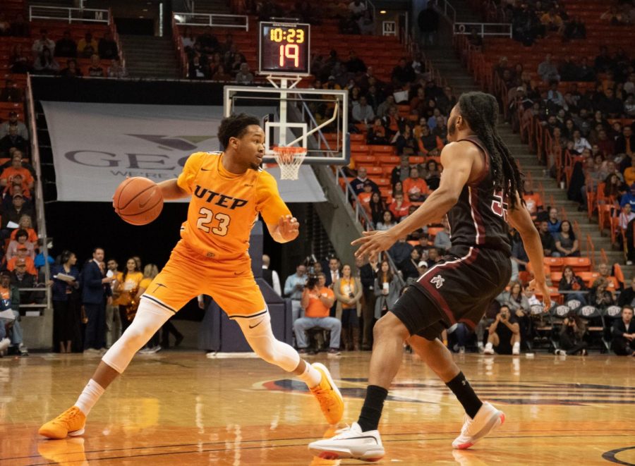 Sophomore guard Nigel Hawkins evades around the defender while playing against NMSU at the Don Haskins Center on Dec.3