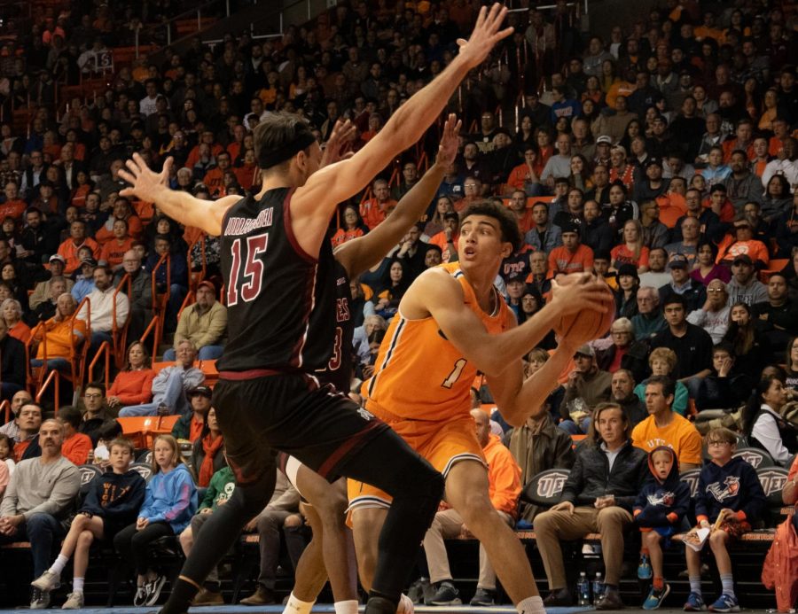 Sophomore forward Tydus Verhoeven makes the difficult pass to his teammate while being heavily covered by two NMSU players at the Don Haskins Center.