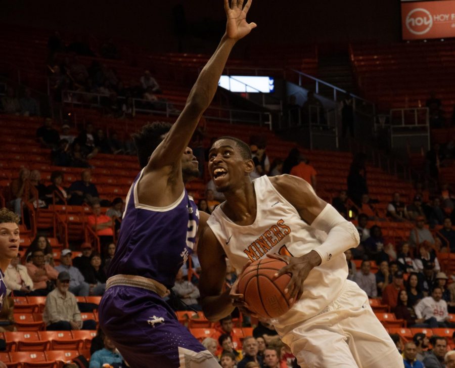 Junior forward Bryson Williams powers through a defender late in the second half to score another two points against New Mexico Highlands University at the Don Haskins Center.