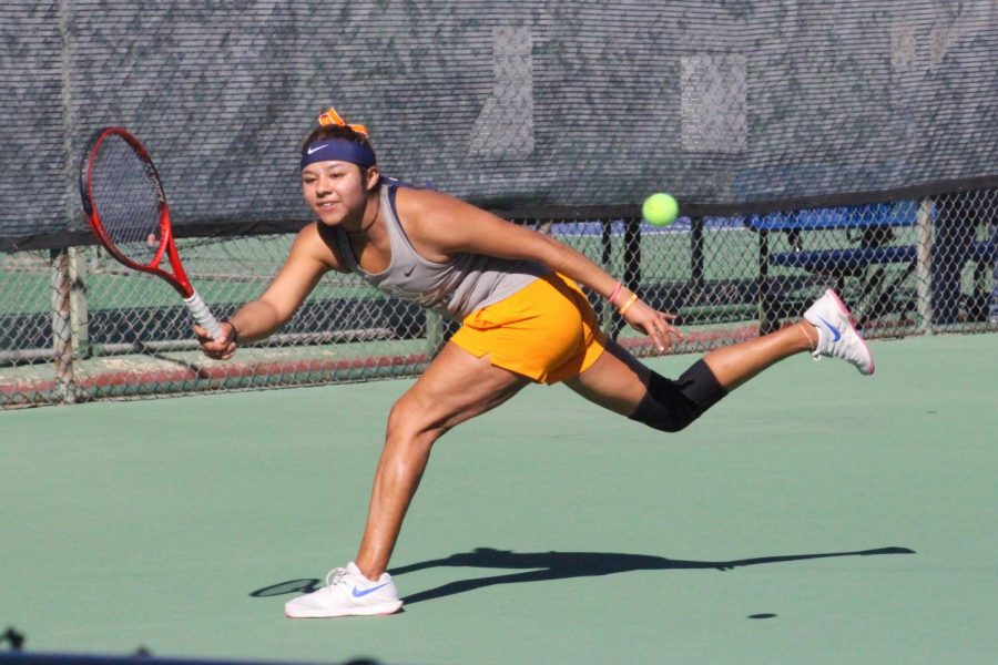 Junior Erandi Martinez dashes to return serve in win versus Eastern New Mexico University Saturday Jan. 25, 2019.