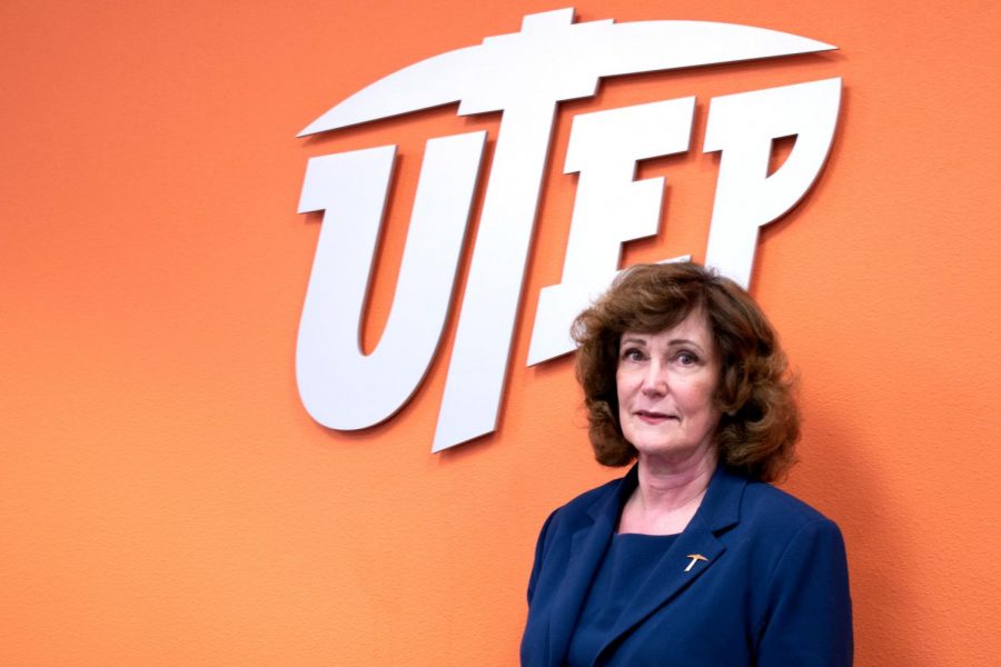 Leslie Robbins , UTEPs new Dean of Nursing, stands beneath the seal of UTEP.