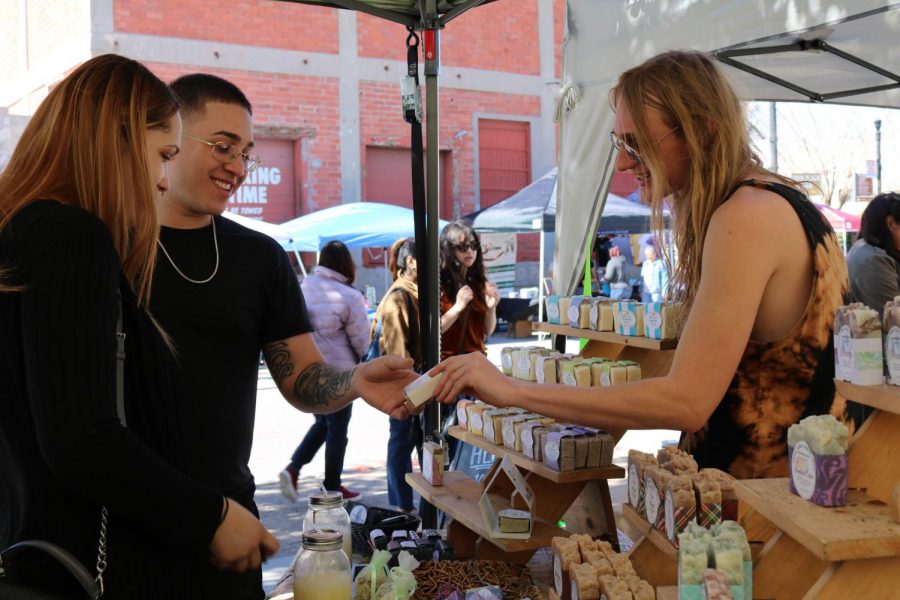 Customers browsing the selection of products offered by Hueco Valley Soaps & Lotions, a business run by Elizabeth Dominguez and her grandson Justice Hill, this past Saturday, Feb. 15 at the El Paso Downtown Artist & Farmers Market.