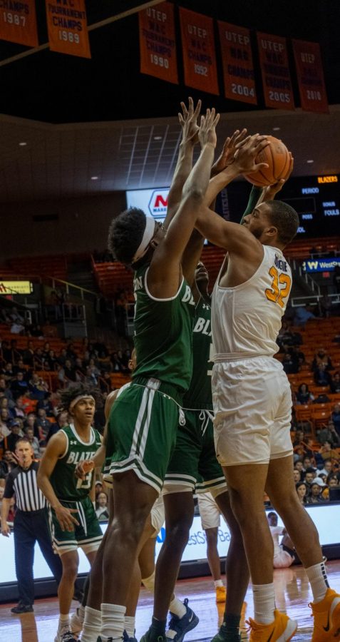 Sophomore forward Efe Odigie takes shot up with two Blazer defenders  trying to alter his shot versus UAB Feb.1.