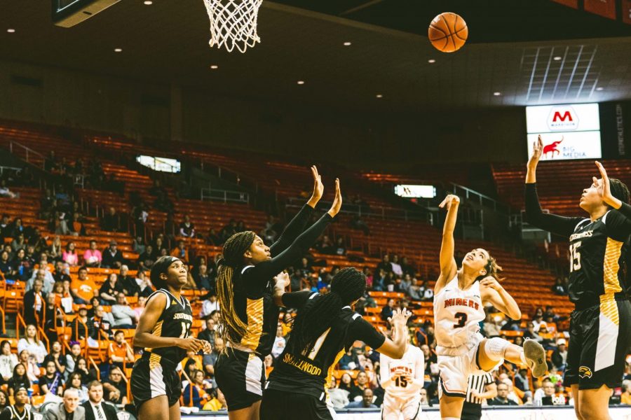 Freshman point guard Katia Gallegos shoots the ball through three Southern Miss defenders Saturday Feb. 29. 