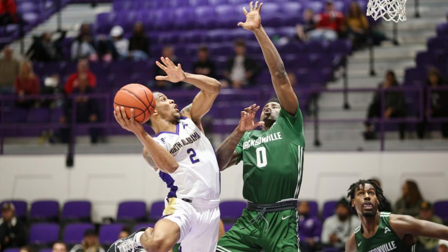 North Alabama sophomore guard Christian Agnew looks to shoot over Jacksonville defender in win Jan. 2. 