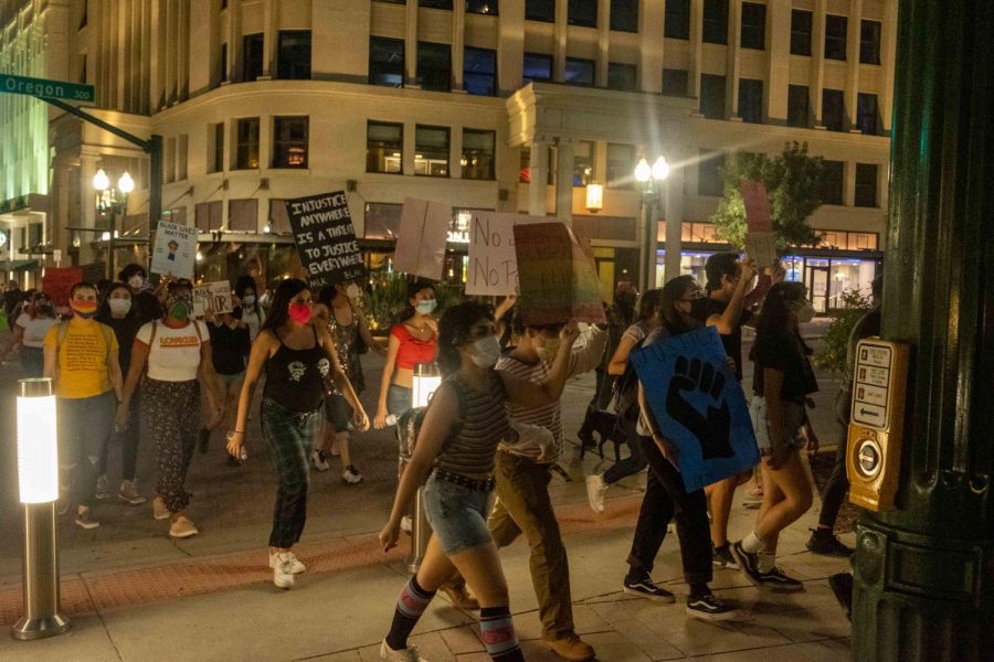 Protesters cross Oregon Street  shoutting  Trans Lives matter during Queer Solidarity March as they gather in San Jacinto Plaza June 13, 2020.