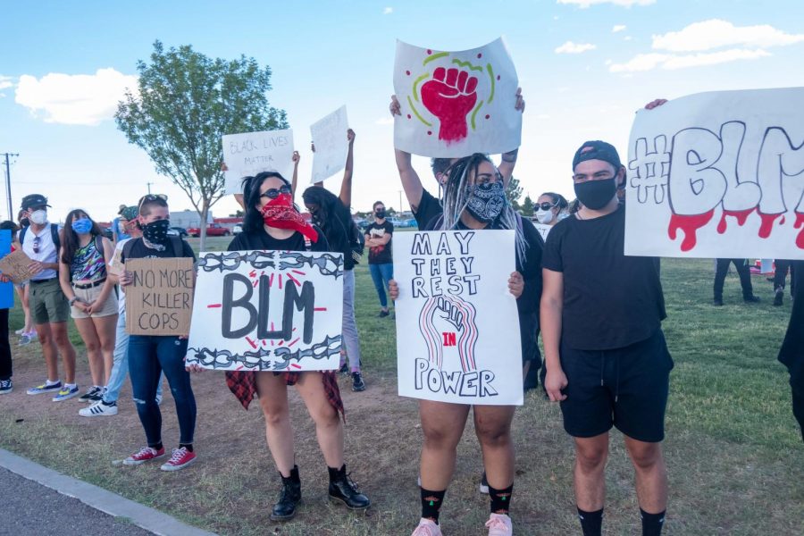 Protesters stand along Rushing Road at Veterans Park to protest police brutality June 19,2020.