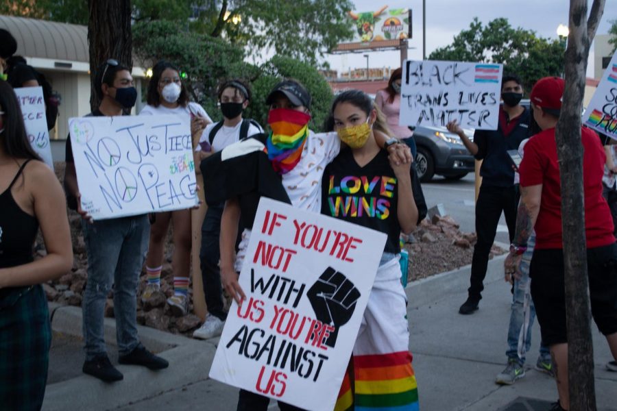 Annika Aguirre, left, and her girlfriend Alyssa Coca embrace while gathering for Queer Solidarity March June 13, 2020.