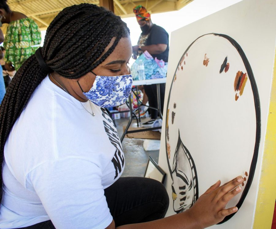 Participant of Juneteenth march at Veterans Park adds her personal touch to a community picture promoting unity June 19, 2020.