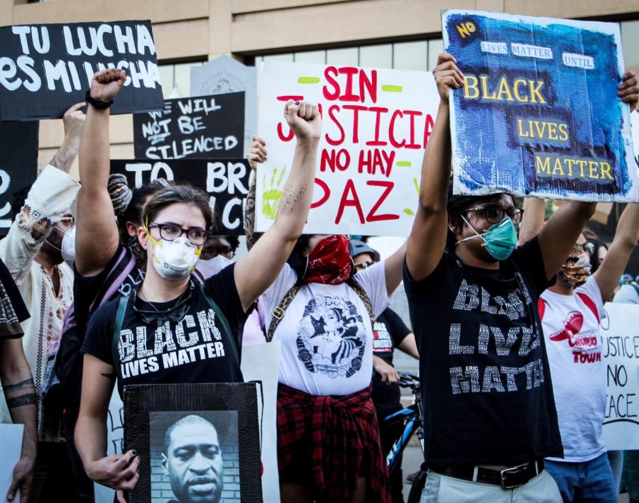 Protestors face the police while holding signs and demanding for justice and peace at Aztec Calendar Park in Downtown El Paso on June 2. 