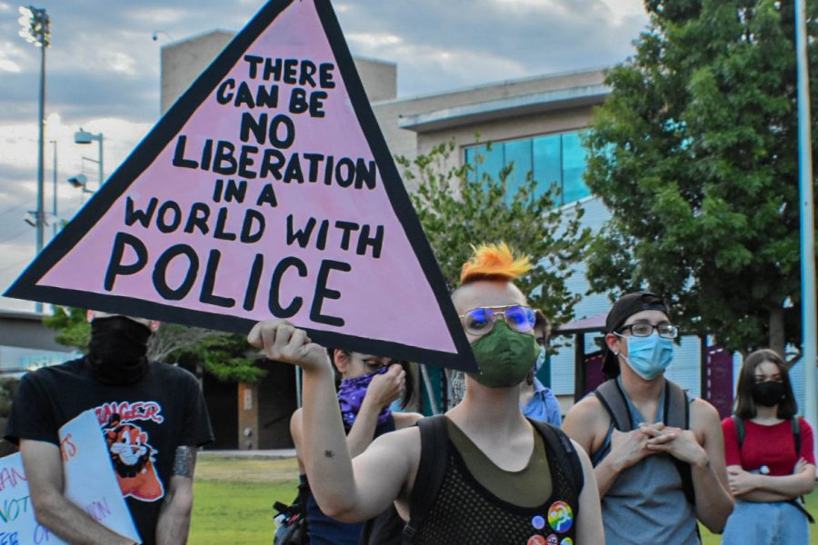 Protester holds up sign denouncing the police during Queer Solidarity March June 13, 2020.