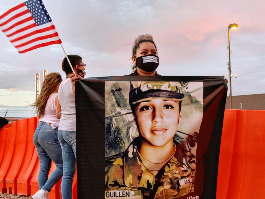 Syvia Galvan a military spouse stands outside of Cassidy Gate of Fort Bliss to demand justice for Vanessa Guillen during protest July 4, 2020.
