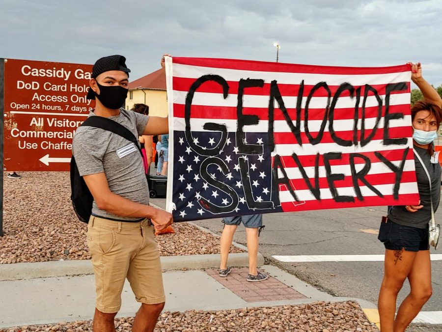 Protesters hold a messaged United States flag in distress outside of Cassidy Gate to Fort Bliss July 4, 2020.