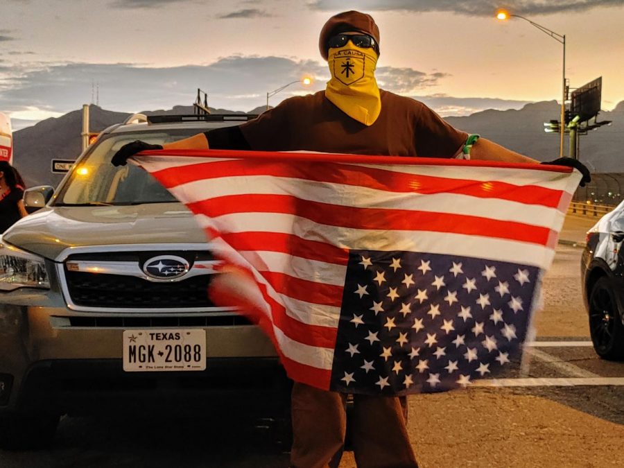 A member of the local Brown Berets holds a United States flag upside down in a protets for justice of Vanessa Guillen outside of Fort Bliss July 4, 2020.