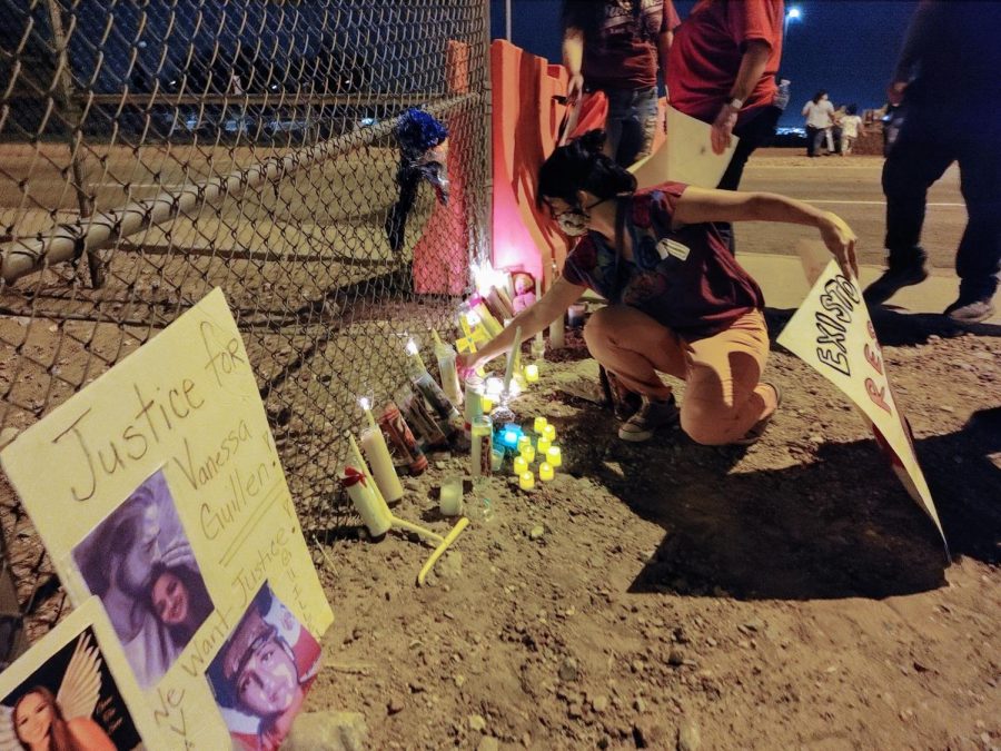 Protester lays down a candle at the edge of the Fort Bliss fence in a memorial to Vanessa Guillen July 4, 2020.