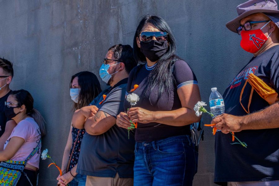 Onlookers gather to pay respects to the Cielo Vista Walmart shooting victims Aug. 3, 2020.