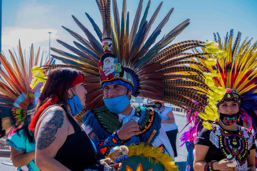 Members  of Danza Azteca Tianeztica gather after performing at Cielo VIsta Walmart memorial honoring the victims of last years mass shooting Aug. 3, 2020.