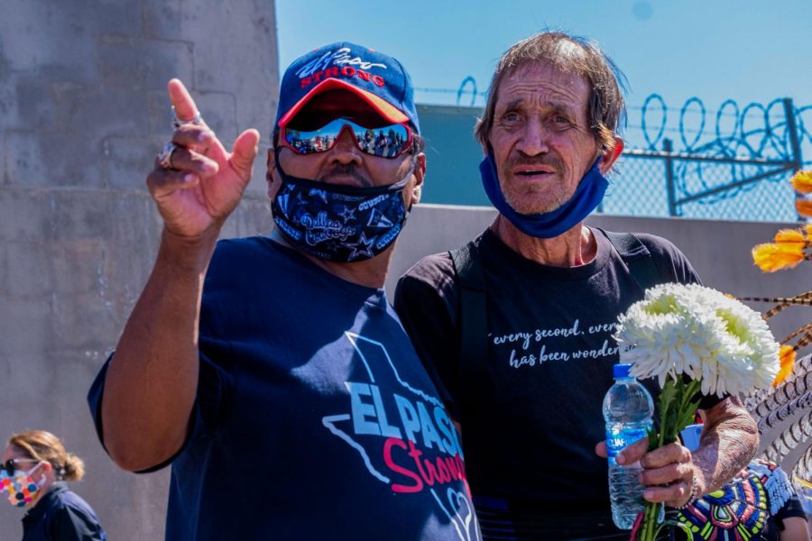 Antonio Basco holds flowers and looks onward at the Walmart memorial commemorating the 23 victims including his own wife Aug. 03, 2020.