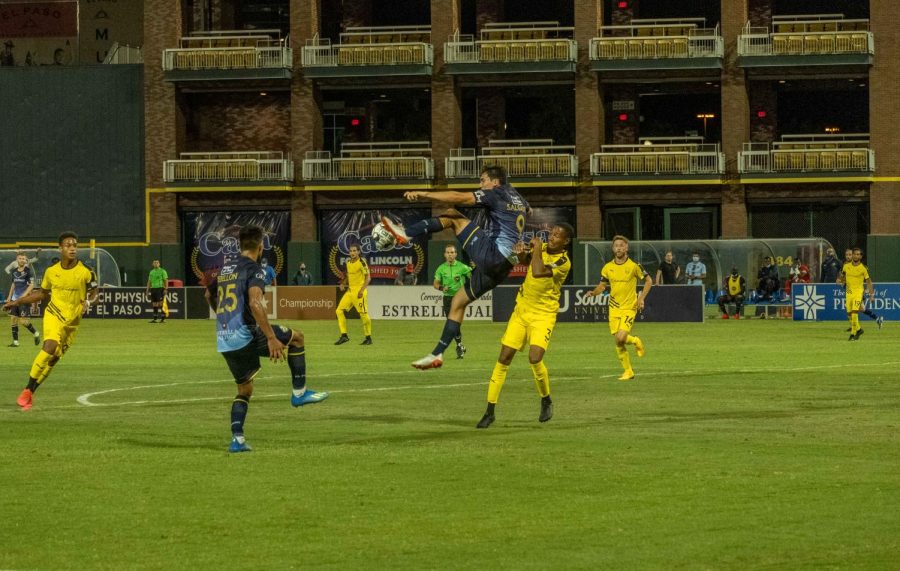 El Paso Locomotive forward Omar Salgado goes up for a high kick  over a defender versus New Mexico United July 15, 2020