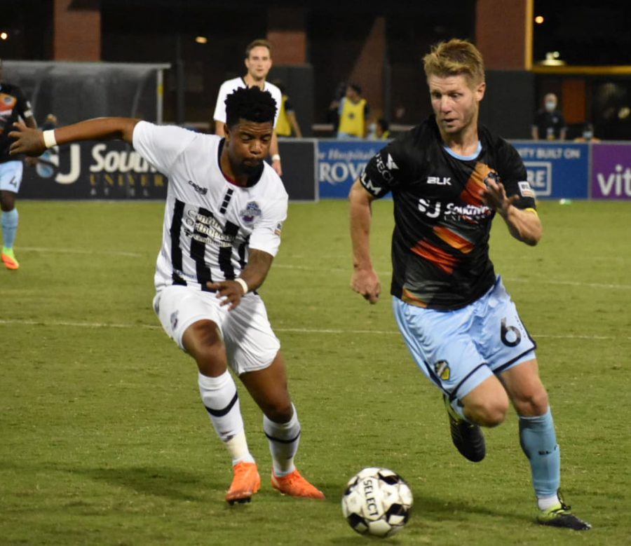 El Paso Locomotive Midfielder Richie Ryan runs against a member of Colorado Springs Swtichbacks at Southwest University Park, Wednesday, Sept.  16.